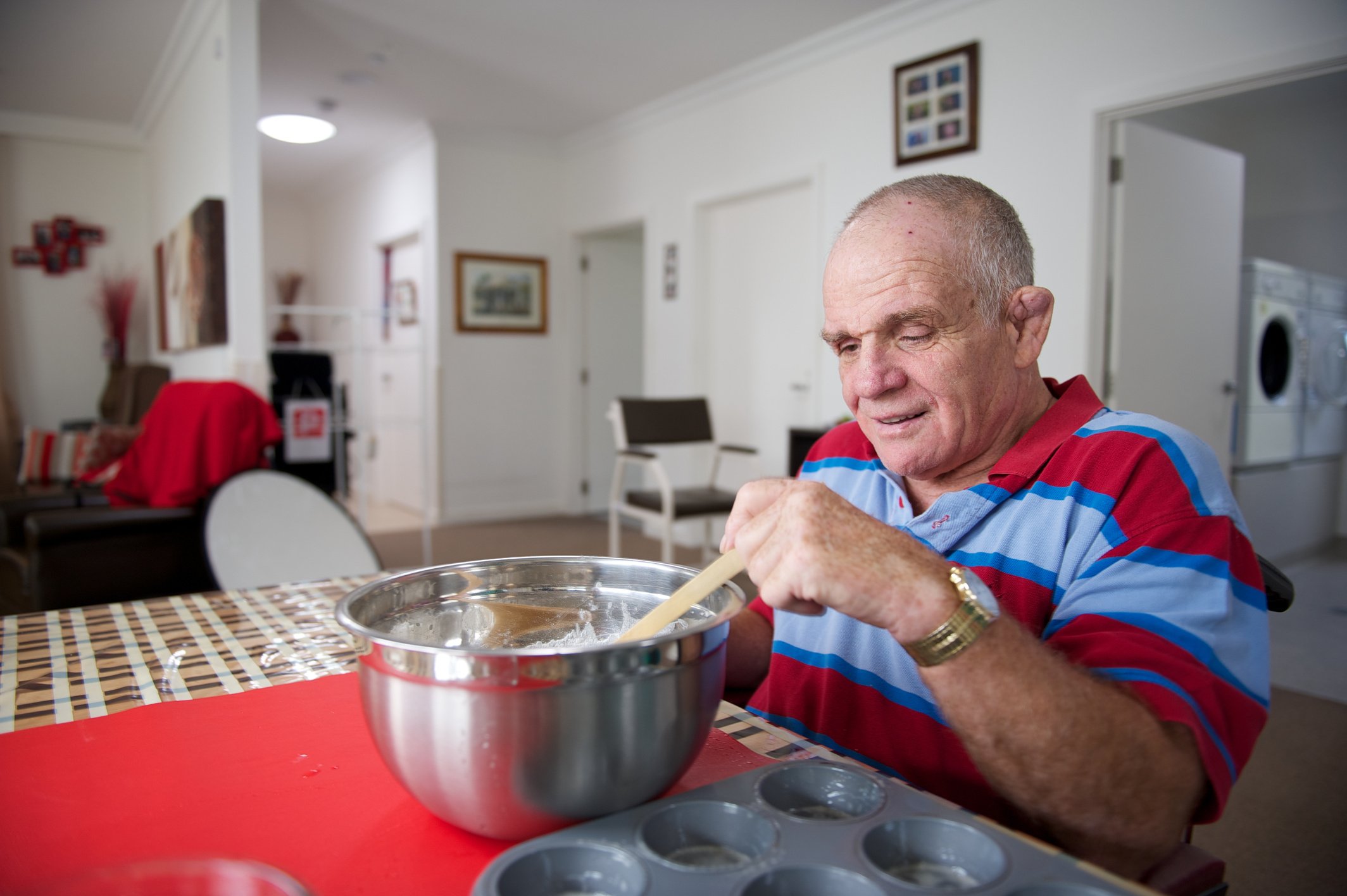 Man with an Intellectual Disability preparing a cake mix